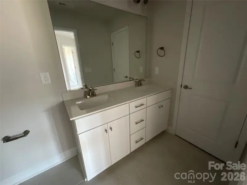 Hall bathroom with dual sinks