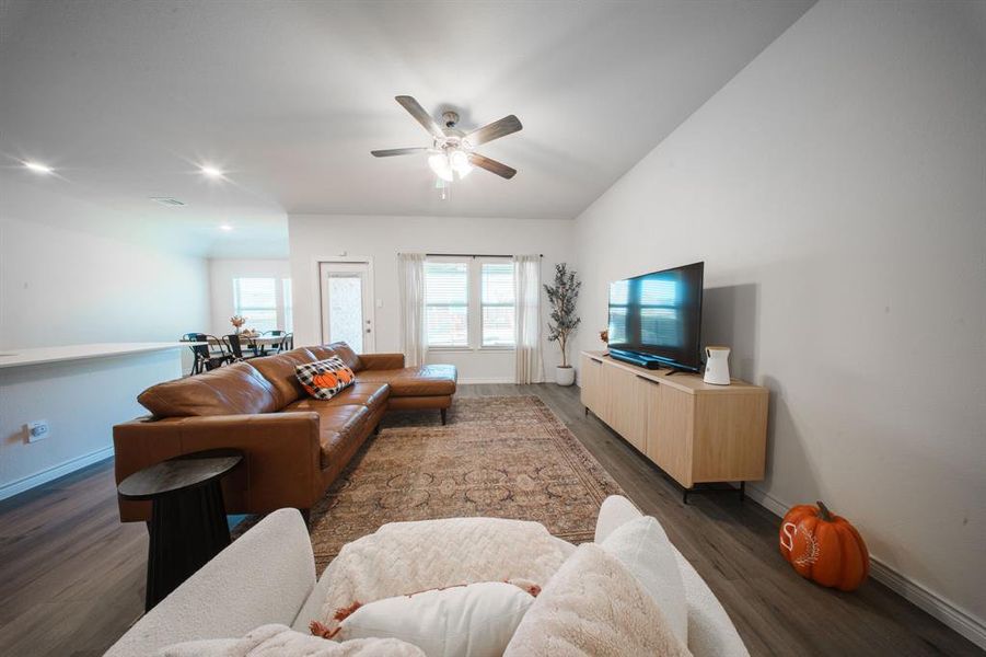 Open Living Room with vinyl plank flooring, tall ceilings & ceiling fan Open Living Room with vinyl plank flooring, tall ceilings & ceiling fan