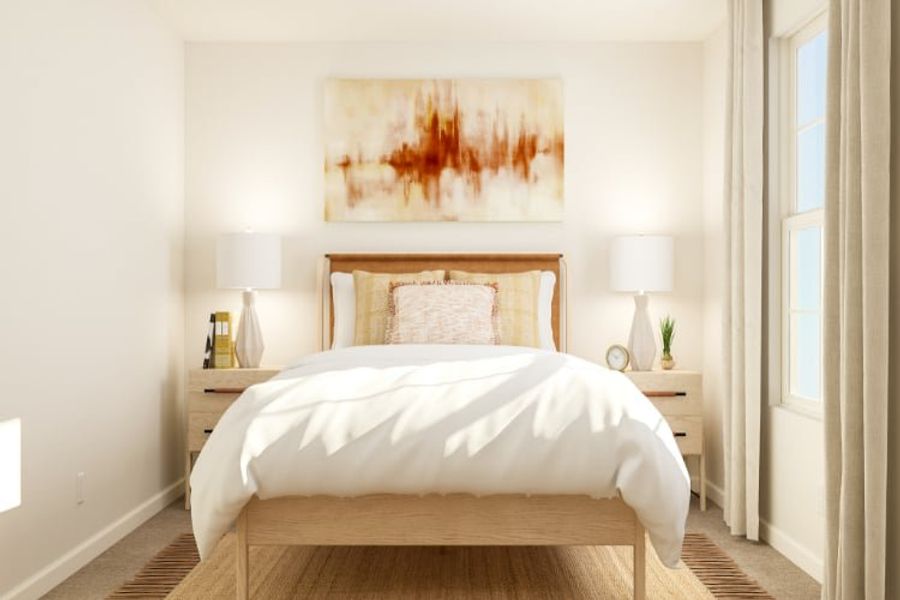 A bed with a painting on the wall.