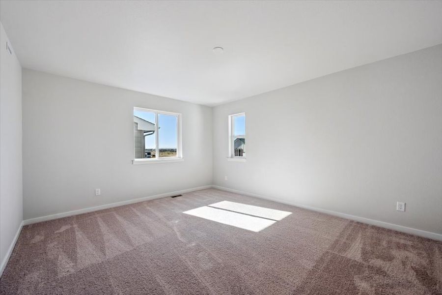 A room with a rug and windows. A room with a rug and windows.