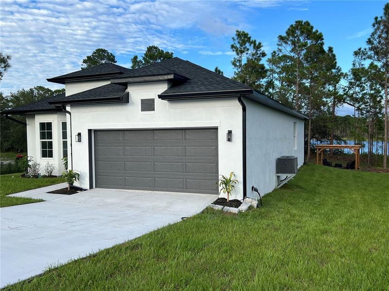 Front exterior of a new home in , Deltona, FL, highlighting curb appeal (Image 22). Front exterior of a new home in , Deltona, FL, highlighting curb appeal (Image 22).