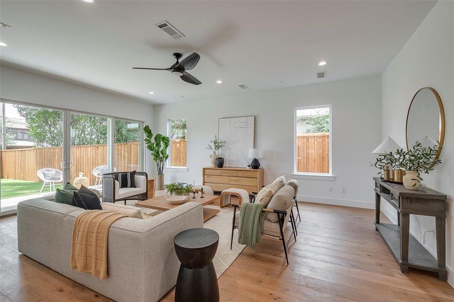 Living room 2 with light hardwood / wood-style floors and ceiling fan