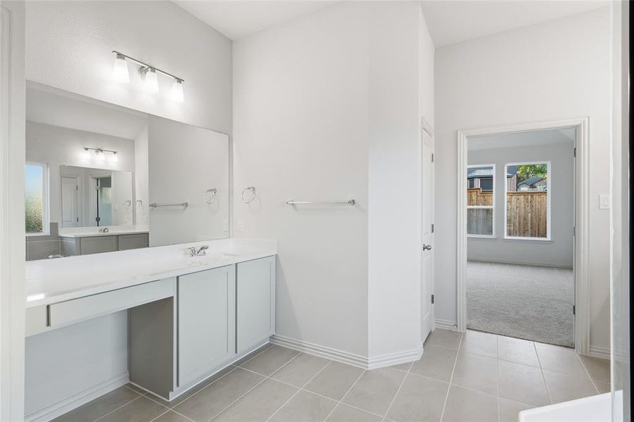 Bathroom with vanity and light tile patterned floors