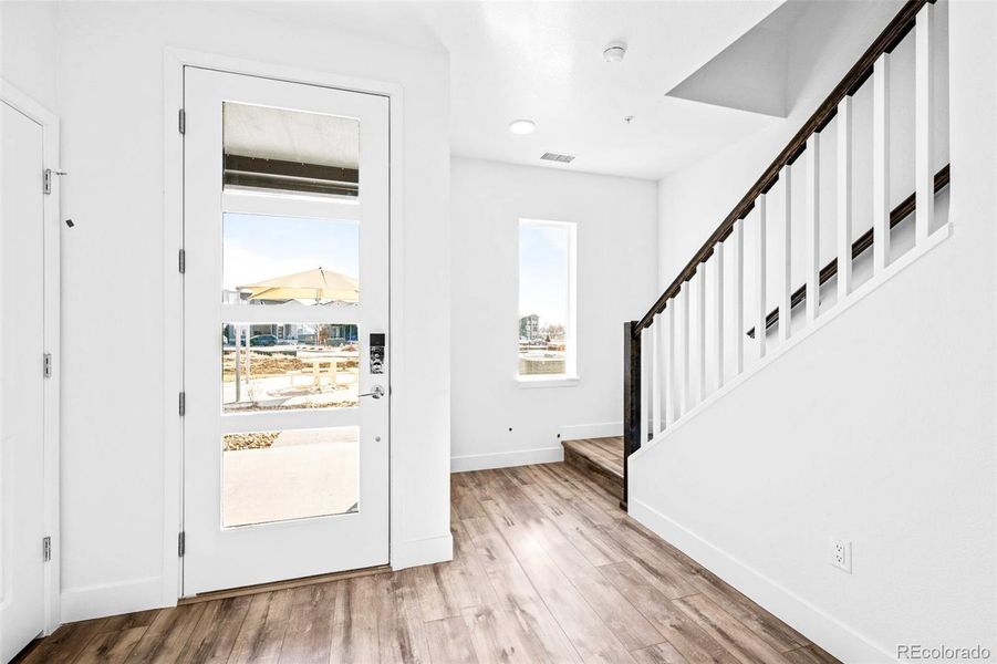 Main level entry with front door, garage access, and half bath.