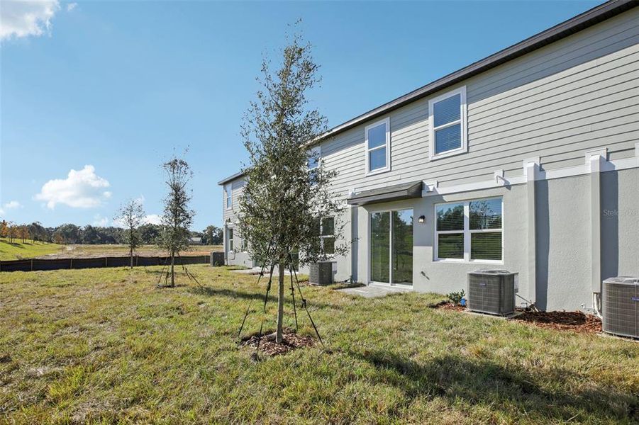 Exterior details and patio area of a home in The Reserve at Hammock Oaks Townes, Lady Lake (Image 4).