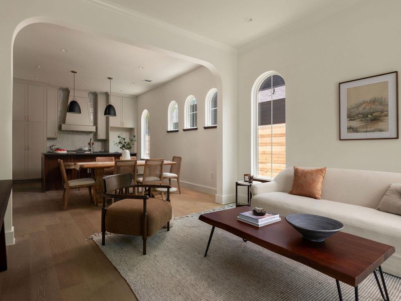 An inviting open-concept space connects a well-appointed kitchen and dining area with a comfortable living room.