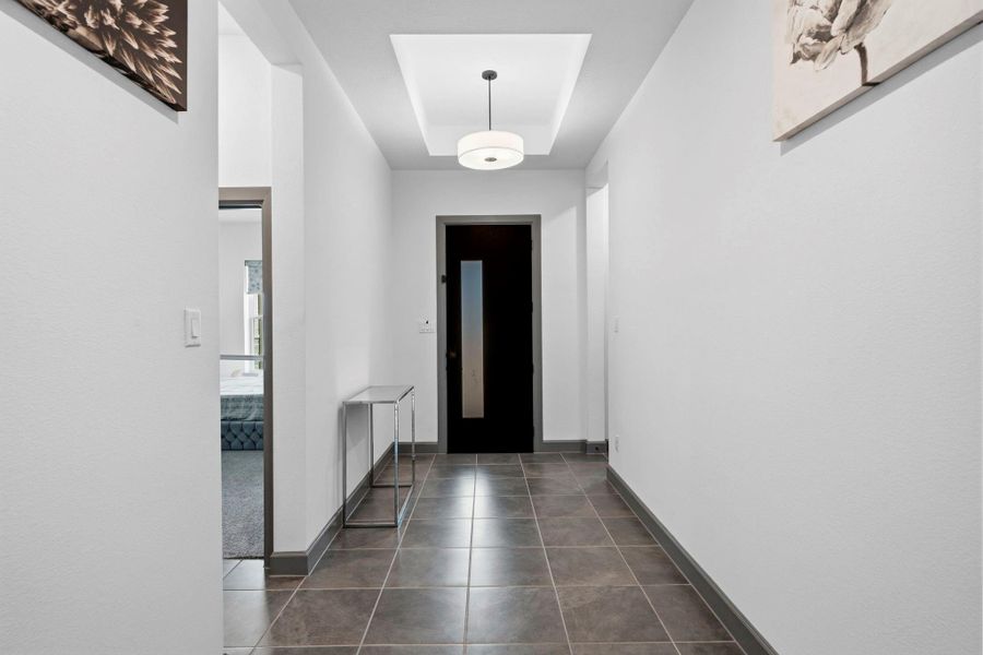 Welcoming interior hallway with clean architectural lines, modern lighting, and sleek tile flooring—creating a bright, elegant transition between living spaces and private quarters.