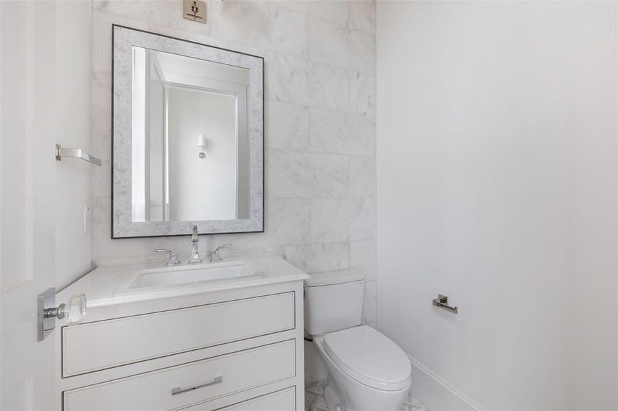 Tucked way on a private landing down the staircase, the second floor half bath features gorgeous finishings and privacy. Image from previously completed home in the community.