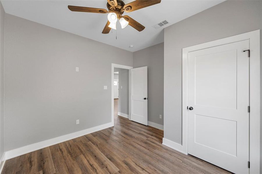 Unfurnished bedroom featuring wood finished floors and a ceiling fan