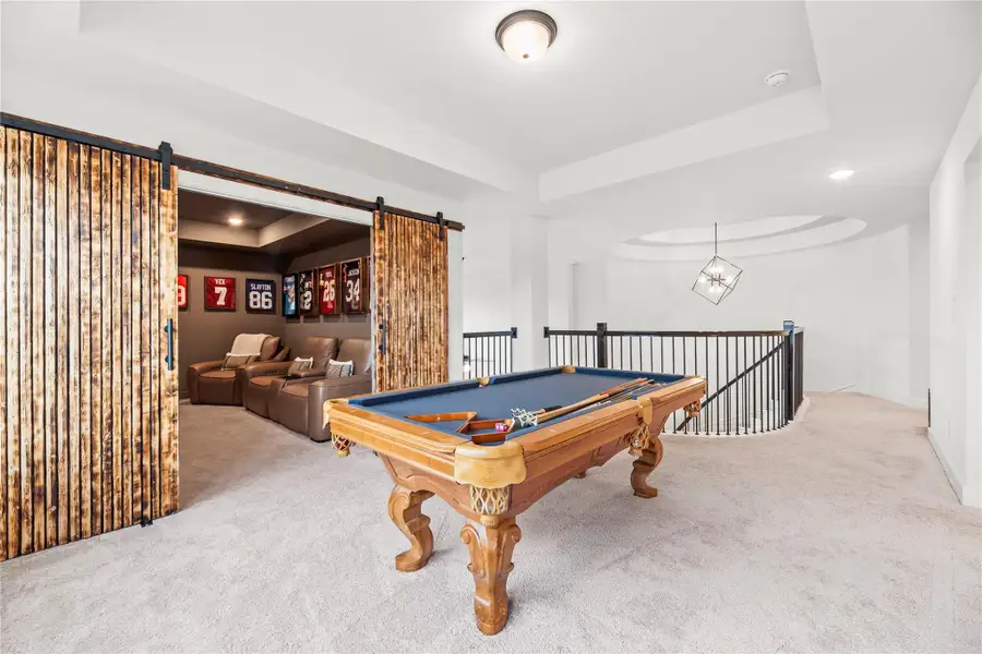 Party central! This upstairs game room and the adjoining media room are built for non-stop fun, from epic game nights to big-screen showdowns, all without ever leaving the comfort of home.