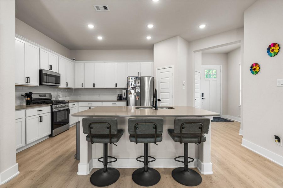 Designed to keep everyday life connected, the main living spaces flow seamlessly together, allowing conversation, meal preparation, and gathering to happen naturally from the moment you walk through the door.