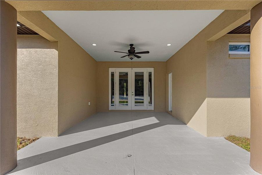 OVERSIZED COVERED LANAI WITH LIGHTING AND ACCESS TO ENSUITE (FUTURE POOL BATH) WITH CEILING FAN