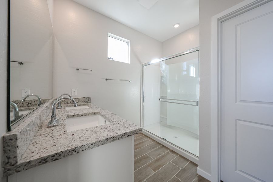 A bathroom with a glass shower. A bathroom with a glass shower.