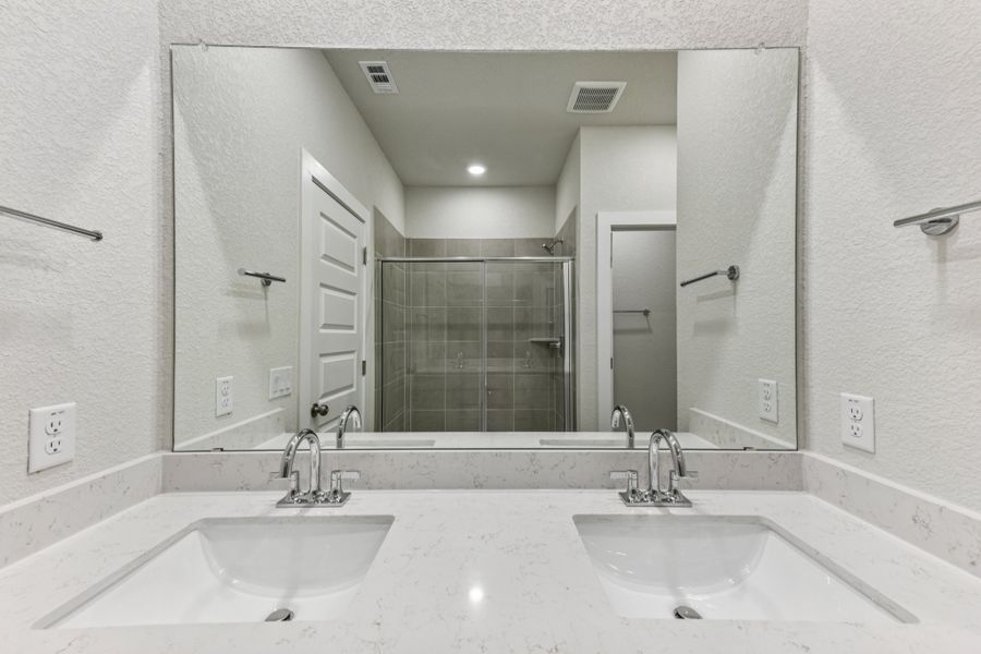 A bathroom with a large mirror.
