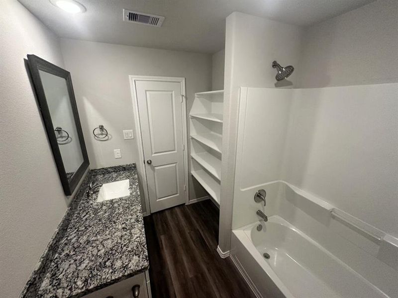 Bath 2 with granite counters + storage shelves