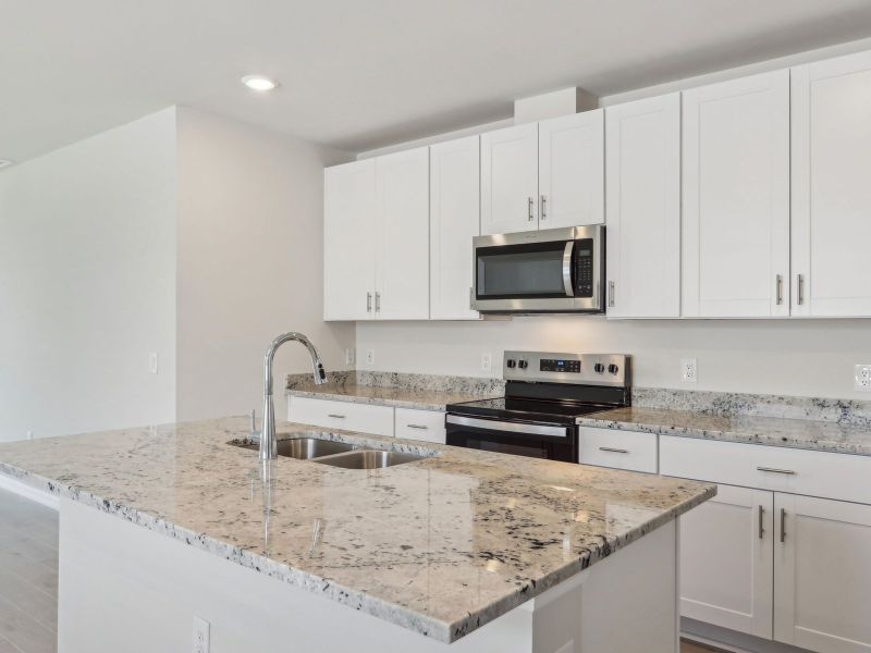 Kitchen in the Ibis floorplan at 44518 Cable Creek Dr