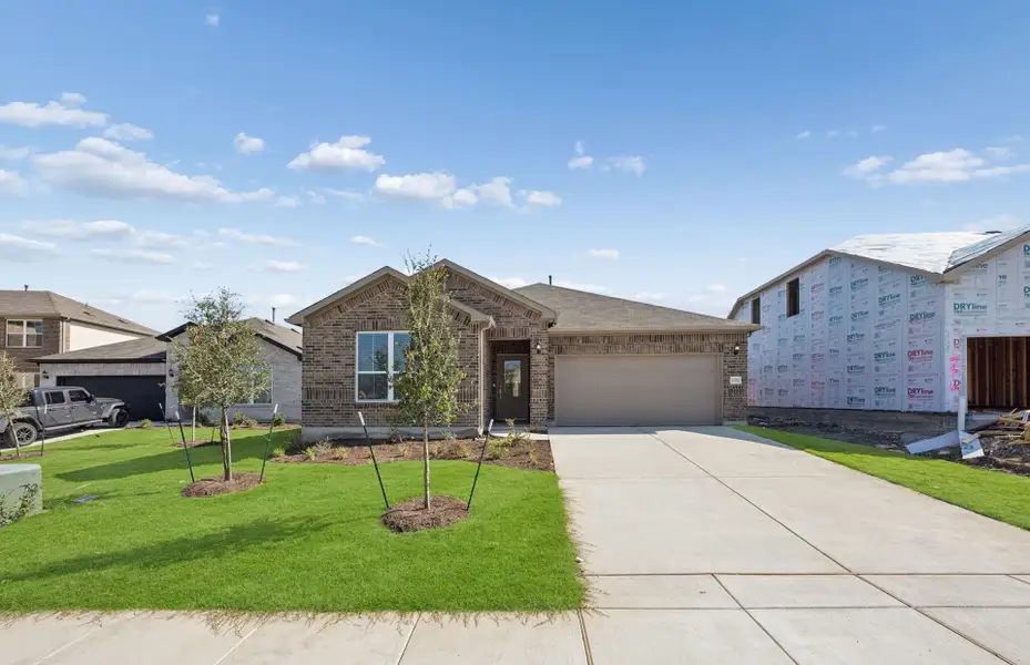 Front exterior of a new home in Lagos, Manor, TX, highlighting curb appeal (Image 19).