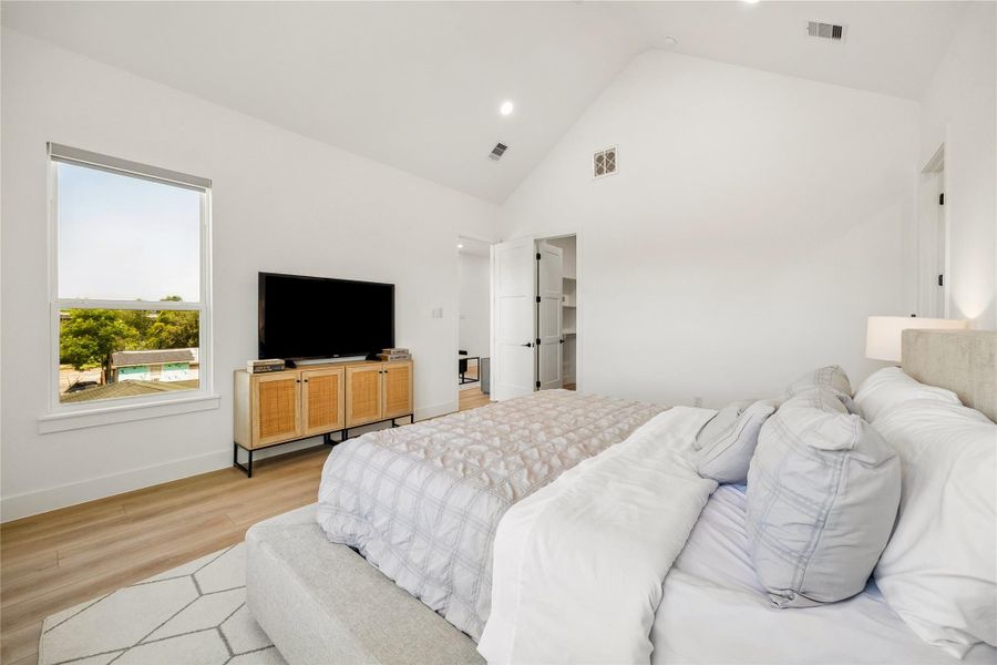 Natural light and warm wood inspired flooring create an inviting atmosphere designed for rest and relaxation.