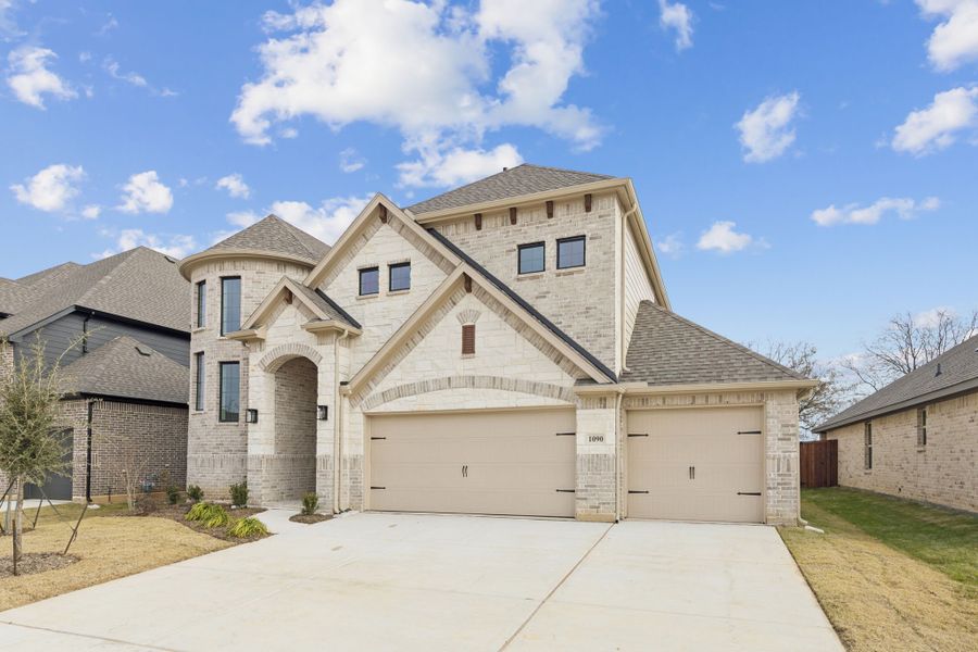 Front exterior of a new home in Timberbrook, Justin, TX, highlighting curb appeal (Image 2). Front exterior of a new home in Timberbrook, Justin, TX, highlighting curb appeal (Image 2).