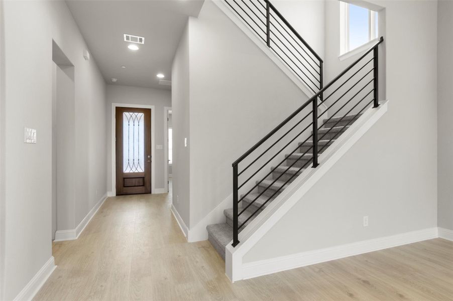 Entrance foyer with light wood-type flooring, recessed lighting, and stairs Entrance foyer with light wood-type flooring, recessed lighting, and stairs