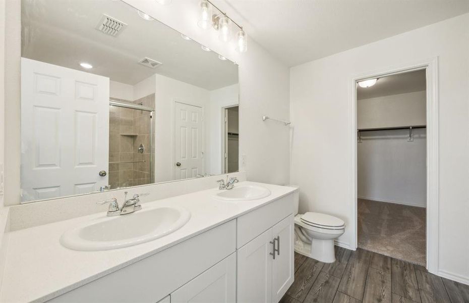 Owner's bathroom with dual vanity *real home pictured