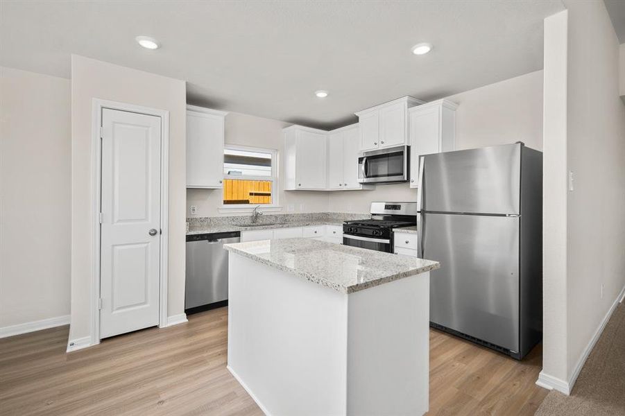 Stainless Steel appliances along with a breakfast bar.