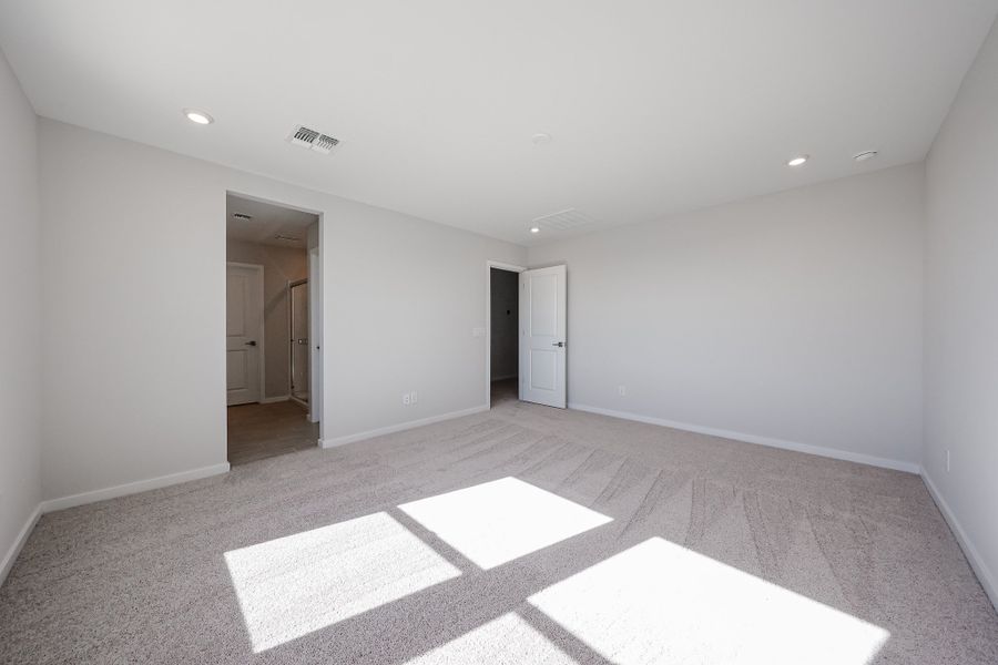 A room with white walls and a rug.