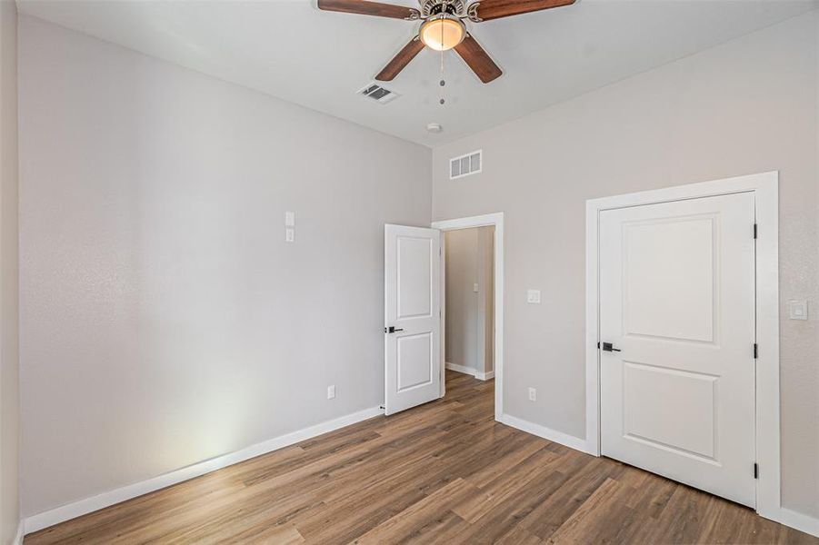 Unfurnished bedroom featuring wood finished floors and ceiling fan