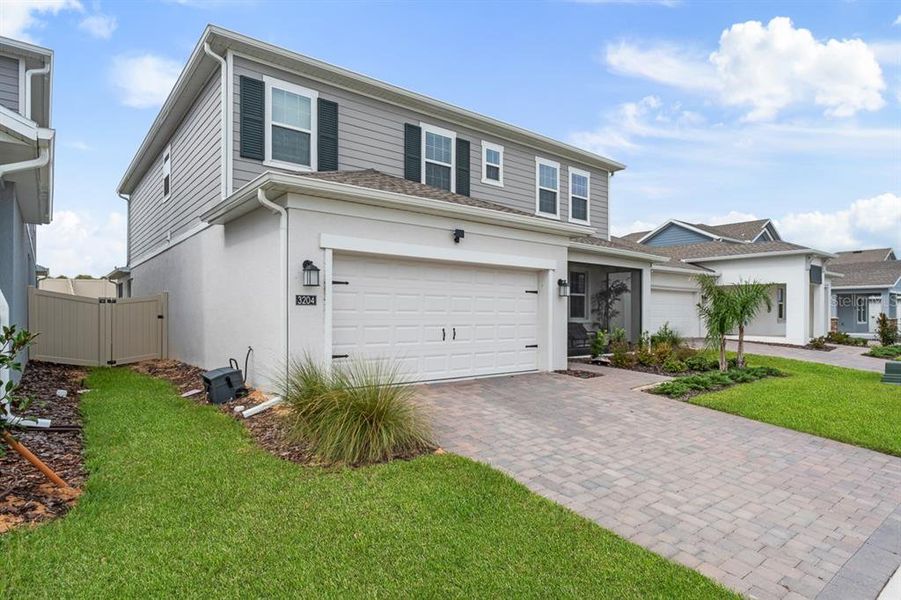 Front exterior of a new home in Wellness Ridge, Clermont, FL, highlighting curb appeal (Image 2). Front exterior of a new home in Wellness Ridge, Clermont, FL, highlighting curb appeal (Image 2).