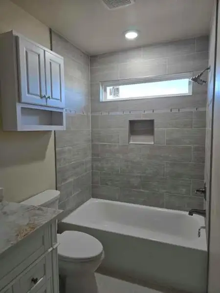 Full bathroom featuring vanity, plenty of natural light, tub / shower combination, and recessed lighting Full bathroom featuring vanity, plenty of natural light, tub / shower combination, and recessed lighting