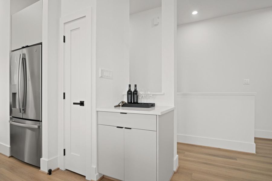 An additional storage closet sits to the right of the refrigerator along with a coffee or bar nook which also provides additional prep space and cabinet storage below. An additional storage closet sits to the right of the refrigerator along with a coffee or bar nook which also provides additional prep space and cabinet storage below.
