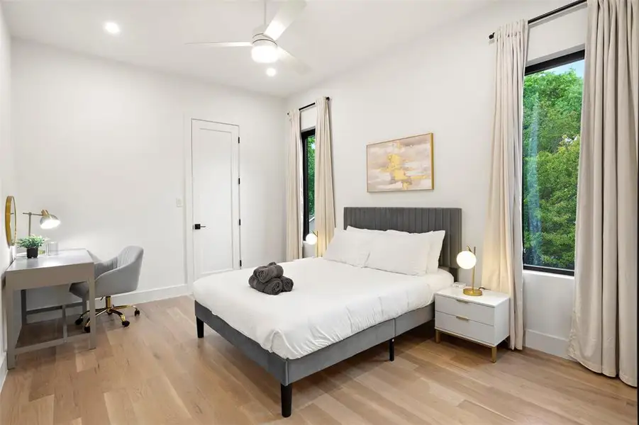 Light wood-finish flooring complements the bright white walls and ceiling