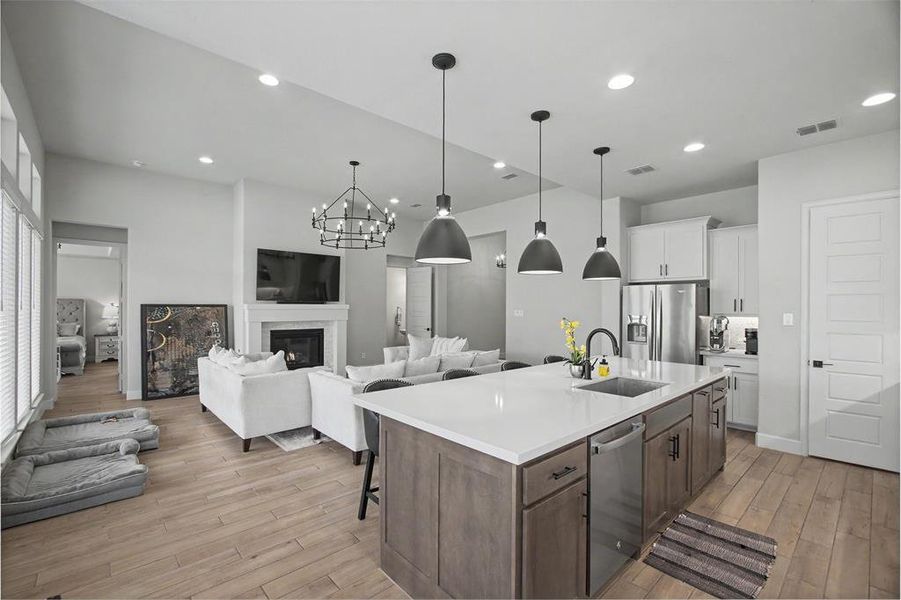 Open-concept living space featuring wood-finish flooring throughout