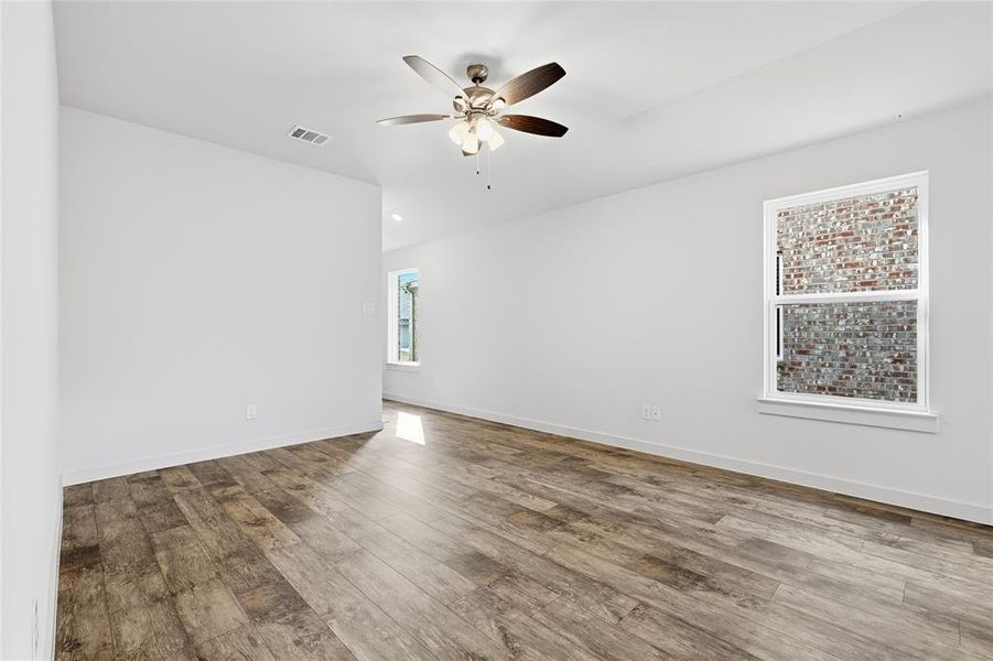 Spare room with hardwood / wood-style flooring and ceiling fan Spare room with hardwood / wood-style flooring and ceiling fan