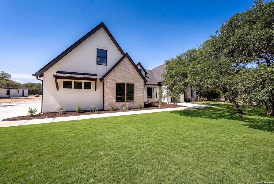 Front exterior of a new home in , Boerne, TX, highlighting curb appeal (Image 25).