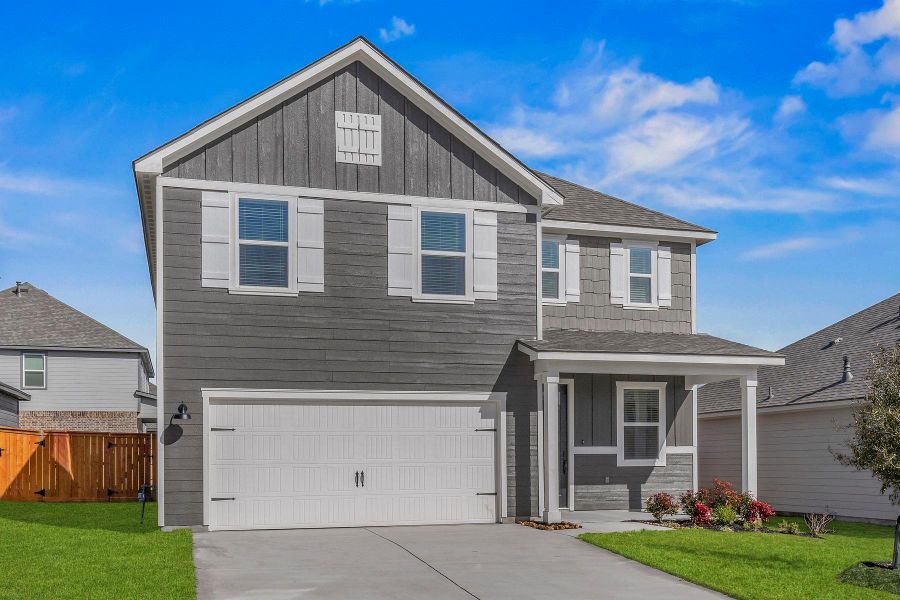 A striking gray residence with white shutters and an inviting front porch awaits. A striking gray residence with white shutters and an inviting front porch awaits.