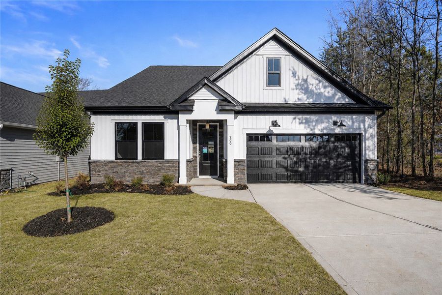 A modern facade with white siding and stone accent A modern facade with white siding and stone accent