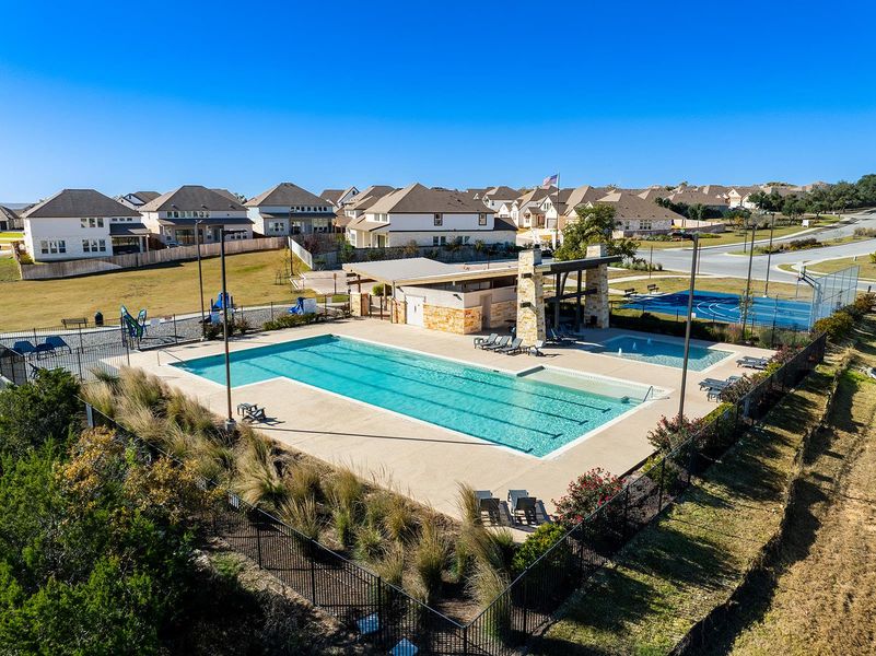 Community pool with a patio and a residential view
