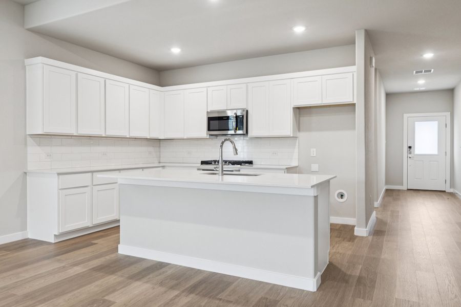 Kitchen in the Stanley II home plan by Trophy Signature Homes – REPRESENTATIVE PHOTO