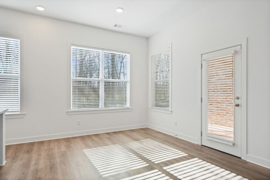 Empty room featuring light wood finished floors and recessed lighting