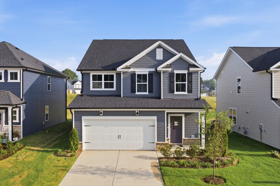 Front exterior of a new home in Providence Oaks, Fuquay Varina, NC, highlighting curb appeal (Image 2). Front exterior of a new home in Providence Oaks, Fuquay Varina, NC, highlighting curb appeal (Image 2).