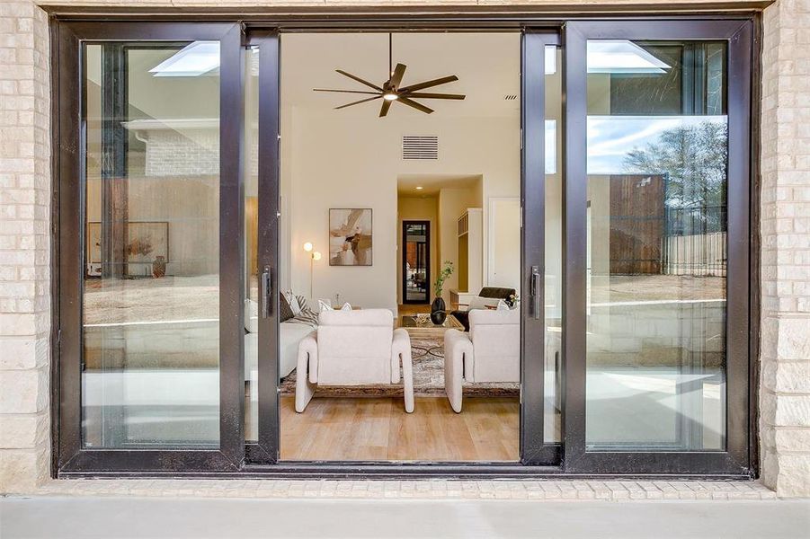 View of exterior entry featuring ceiling fan