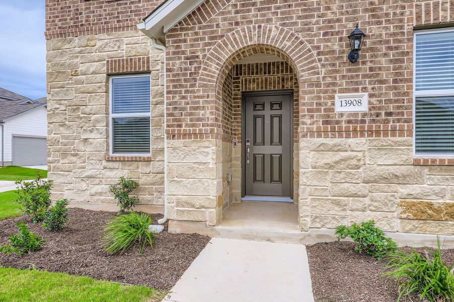 Property entrance with stone siding and brick siding Property entrance with stone siding and brick siding