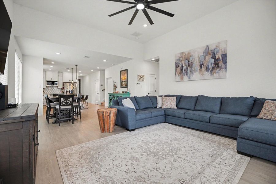 Spacious living room featuring soaring ceilings, expansive windows, and an open design that enhances the home's bright and airy feel. Spacious living room featuring soaring ceilings, expansive windows, and an open design that enhances the home's bright and airy feel.