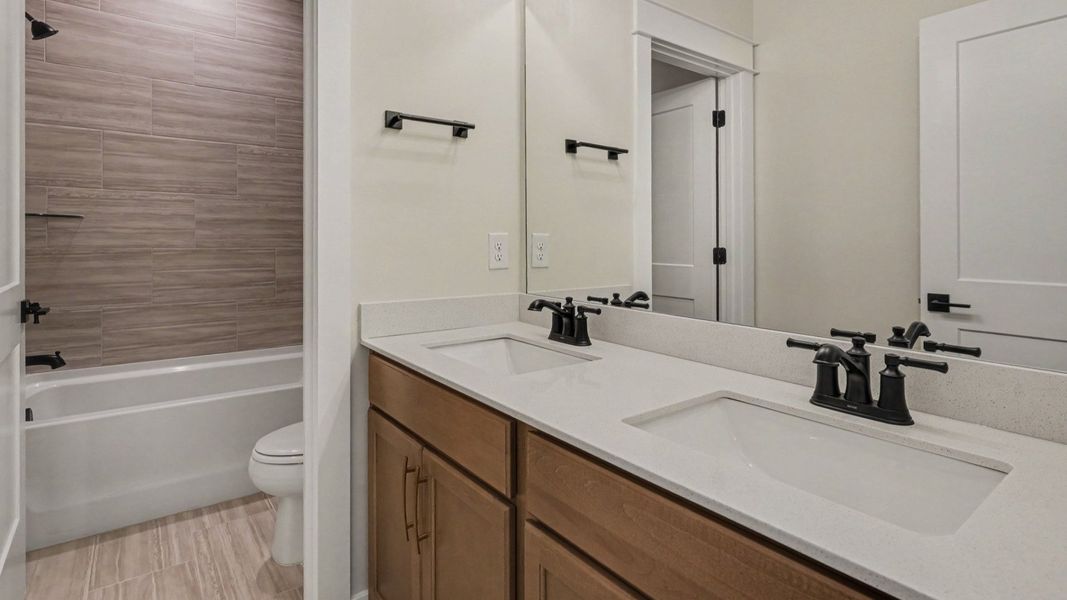 Bathroom with bathtub and dual vanities Bathroom with bathtub and dual vanities