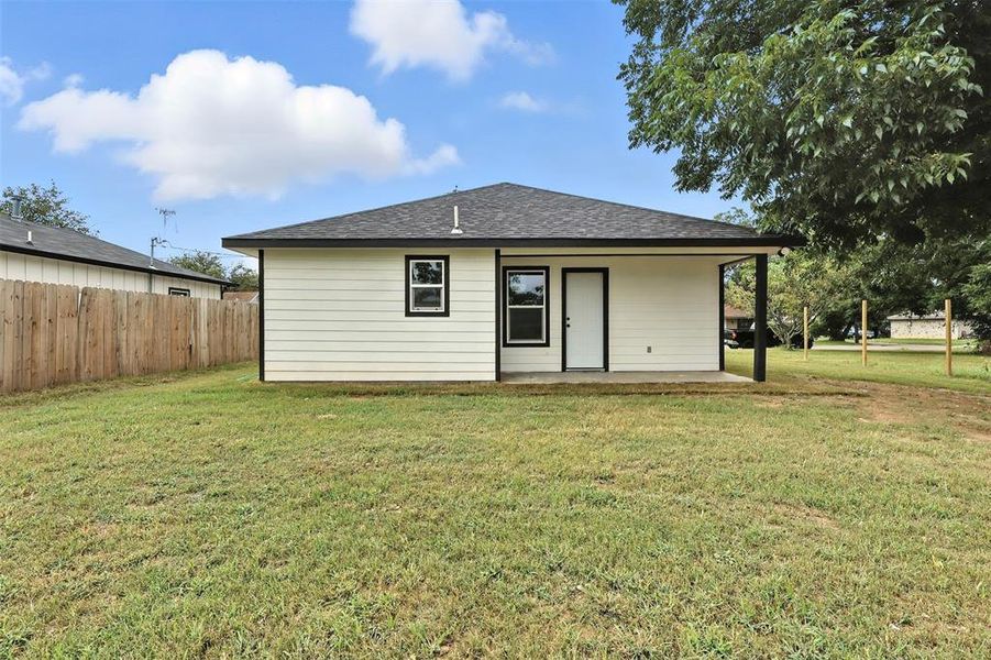 Rear view of house with a shingled roof Rear view of house with a shingled roof
