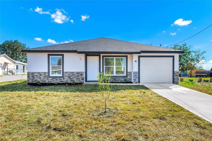 Front exterior of a new home in , Haines City, FL, highlighting curb appeal (Image 2). Front exterior of a new home in , Haines City, FL, highlighting curb appeal (Image 2).