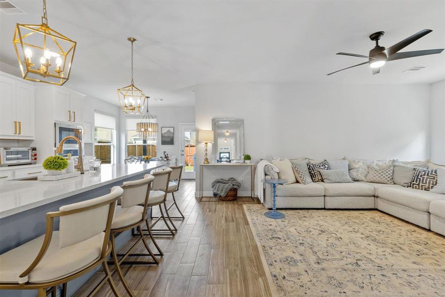 The kitchen provides ample eating options, from the spacious island with seating to a charming eat-in area that overlooks the backyard. This setup is ideal for casual dining, entertaining, and enjoying meals with family and friends.