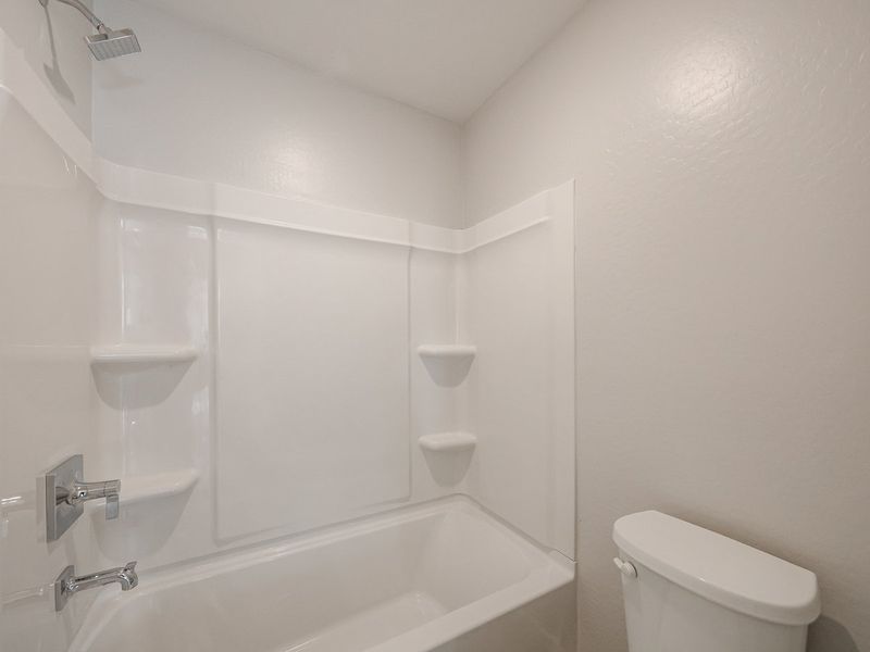 A bathroom with a tub toilet and sink.