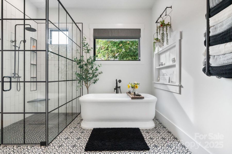 Elegant soaking tub with black fixtures for a spa-like feel Elegant soaking tub with black fixtures for a spa-like feel
